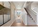 Inviting foyer with wood floors leads to a bright and airy living space, complete with staircase and decor at 1415 Orchard St, Brighton, CO 80601