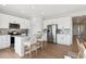 Beautiful kitchen with white cabinets, stainless steel appliances, and a breakfast bar with seating at 1415 Orchard St, Brighton, CO 80601