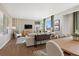 Open-concept living and dining area is bathed in natural light, with views of the well-manicured outdoors at 1415 Orchard St, Brighton, CO 80601