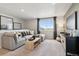 Comfortable loft with plush seating, large window, and entertainment center, perfect for relaxing at 1415 Orchard St, Brighton, CO 80601