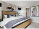 Comfortable primary bedroom featuring a bed with an upholstered headboard, patterned wallpaper, and ensuite bathroom at 1415 Orchard St, Brighton, CO 80601