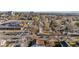 Scenic aerial view of a neighborhood street with mature trees, businesses, and distant mountains at 3073 S Elati St, Englewood, CO 80110
