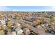 Wide aerial view of the neighborhood with mature trees, clear streets, and city in the distance at 3073 S Elati St, Englewood, CO 80110