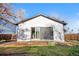 Backyard view of a home featuring a large sliding door, some grass, and a wood fence at 3073 S Elati St, Englewood, CO 80110