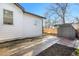 Side view of house backyard featuring a shed and driveway, enclosed by a wooden fence for privacy at 3073 S Elati St, Englewood, CO 80110