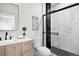 Modern bathroom featuring sleek black fixtures, white tile, and a glass-enclosed shower at 3073 S Elati St, Englewood, CO 80110