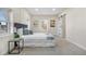 Bright bedroom featuring a comfortable bed, artwork, and a sliding door leading to the bathroom at 3073 S Elati St, Englewood, CO 80110