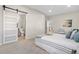 Bedroom with modern sliding barn door leading to a bathroom; bright, clean, and comfortable at 3073 S Elati St, Englewood, CO 80110