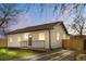 Beautiful house with a well-lit front porch, a gravel driveway, and a new fence at 3073 S Elati St, Englewood, CO 80110