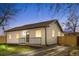 Beautiful house with a well-lit front porch, a gravel driveway, and a new fence at 3073 S Elati St, Englewood, CO 80110