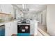 Spacious kitchen with white cabinets, stainless appliances, and open view to the living area at 3073 S Elati St, Englewood, CO 80110