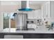 Open kitchen with stainless steel appliances, island, and a view to the backyard at 3073 S Elati St, Englewood, CO 80110