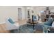 Stylishly decorated living space with an open layout and views to the kitchen and bedroom at 3073 S Elati St, Englewood, CO 80110