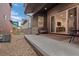 Backyard featuring gravel landscaping, patio, and the modern exterior of the home at 6052 N Malta St, Aurora, CO 80019