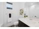 Modern bathroom with sleek fixtures, white subway tile and a dark vanity at 6052 N Malta St, Aurora, CO 80019