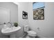 Modern powder bathroom featuring vessel sink, contemporary fixtures, and decorative art at 6052 N Malta St, Aurora, CO 80019