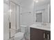 Bright bathroom featuring a white subway tile shower with glass enclosure and a modern vanity at 6052 N Malta St, Aurora, CO 80019