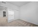 Bright bedroom features neutral carpet, white walls, and closet with sliding doors at 6052 N Malta St, Aurora, CO 80019