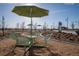 Community area with shaded seating, tables, chairs, and landscaping with walking path at 6052 N Malta St, Aurora, CO 80019