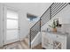 Bright entryway featuring a modern staircase, white door, and stylish console table at 6052 N Malta St, Aurora, CO 80019