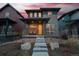 Charming home featuring a stone porch and a bright yellow front door, complemented by a landscaped front yard at 6052 N Malta St, Aurora, CO 80019