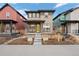 Attractive home with a bright yellow door, modern design, and landscaped front yard at 6052 N Malta St, Aurora, CO 80019