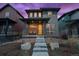 Modern two-story home with a yellow front door, stone accents, and landscaped front yard at 6052 N Malta St, Aurora, CO 80019