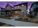 Charming home featuring a well-manicured yard and inviting front porch with seating area at 6052 N Malta St, Aurora, CO 80019