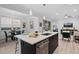 This well-lit kitchen features a large island, stainless steel appliances and is open to both the dining and living room at 6052 N Malta St, Aurora, CO 80019