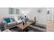Inviting living room with light wood floors, area rug, sofa and accent chairs at 6052 N Malta St, Aurora, CO 80019