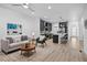 Bright and modern living room open to the kitchen, offering a spacious and inviting atmosphere at 6052 N Malta St, Aurora, CO 80019