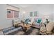 Cozy living room with stylish furniture, area rug and bright natural light from window at 6052 N Malta St, Aurora, CO 80019