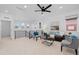 Bright upstairs living room with modern furnishings, ceiling fan, and large windows at 6052 N Malta St, Aurora, CO 80019