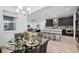 Open-concept layout with dining area, kitchen island with seating, and a spacious living room perfect for entertaining at 6052 N Malta St, Aurora, CO 80019