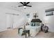 Cozy primary bedroom boasts modern ceiling fan, ample natural light, and stylish decor at 6052 N Malta St, Aurora, CO 80019