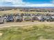 Aerial view of homes situated on a golf course community, with mountain views at 15004 Verbena St, Thornton, CO 80602