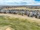 An aerial shot of a residential community surrounded by green spaces and golf course fairways at 15004 Verbena St, Thornton, CO 80602