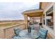 Inviting back deck featuring a dining set, grill, and scenic views of the community at 15004 Verbena St, Thornton, CO 80602