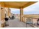 Inviting back deck featuring a dining set, grill, and scenic views of the golf course at 15004 Verbena St, Thornton, CO 80602