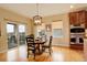 Cozy breakfast nook with hardwood floors, natural light and sliding glass door to the patio at 15004 Verbena St, Thornton, CO 80602
