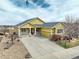 Charming one-story home with welcoming front porch, stone accents, and a spacious driveway at 15004 Verbena St, Thornton, CO 80602