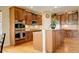 Modern kitchen with stainless steel appliances, granite countertops and custom wood cabinets at 15004 Verbena St, Thornton, CO 80602