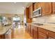 Gourmet kitchen with granite countertops, stainless steel appliances, and gas range at 15004 Verbena St, Thornton, CO 80602