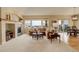 Bright living room features a fireplace, tan sectional sofa, and access to the balcony at 15004 Verbena St, Thornton, CO 80602
