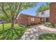 Charming brick condo with a lush, green lawn and mature trees in a tranquil community at 6330 E Wesley Ave, Denver, CO 80222