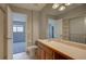 Bathroom featuring a shower, a toilet, and a sink with a large mirror and cabinet storage at 1060 S Parker Rd # 9, Denver, CO 80231