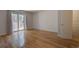 Bright bedroom featuring wood floors, sliding glass doors, and a white painted brick accent wall at 1060 S Parker Rd # 9, Denver, CO 80231