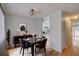 Cozy dining room with modern black table set and decorative pendant lighting, adjacent to the bright kitchen at 1060 S Parker Rd # 9, Denver, CO 80231