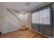 Bright entryway featuring a staircase, window with blinds, and hardwood floors at 1060 S Parker Rd # 9, Denver, CO 80231