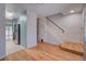Entryway featuring hardwood floors, staircase, and access to a modern kitchen at 1060 S Parker Rd # 9, Denver, CO 80231